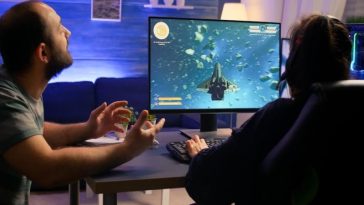 Two players intensely focused on Aviator strategy game screen